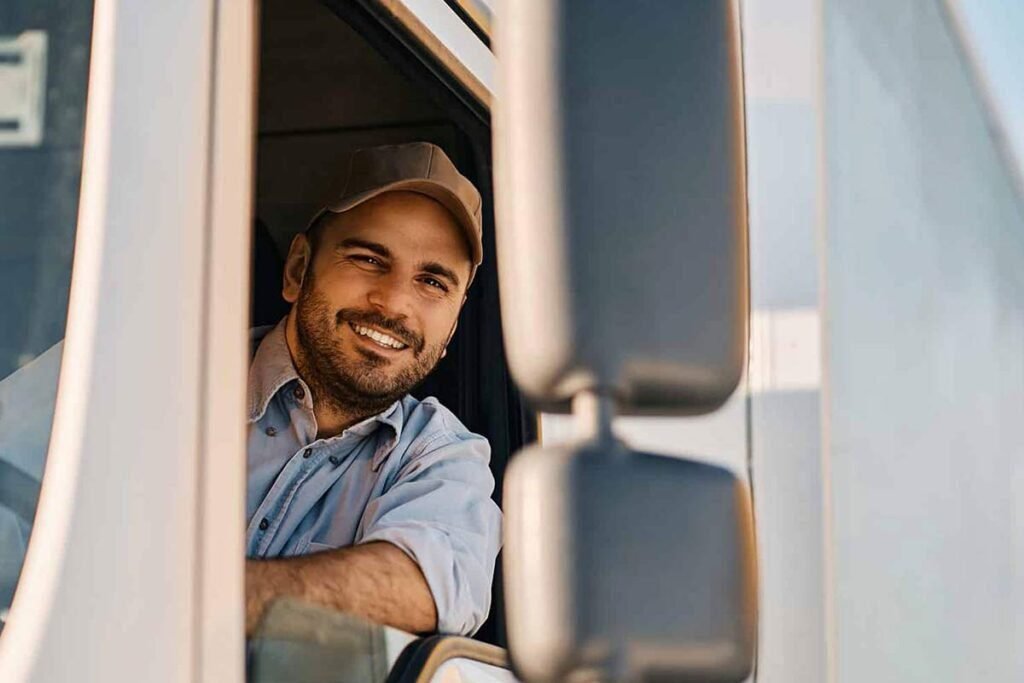 Truck Driver is posing with happy face in truck