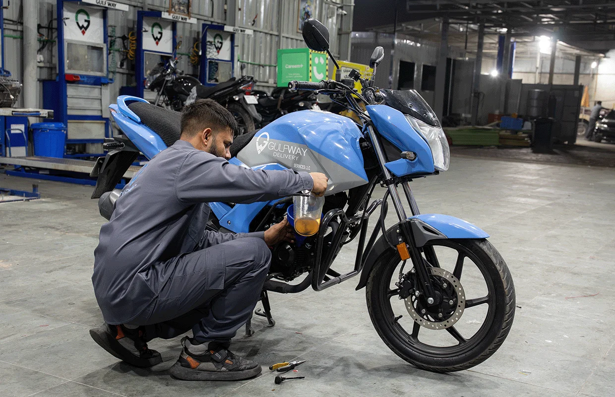 Mechanic Changing the Engine Oil of Bike