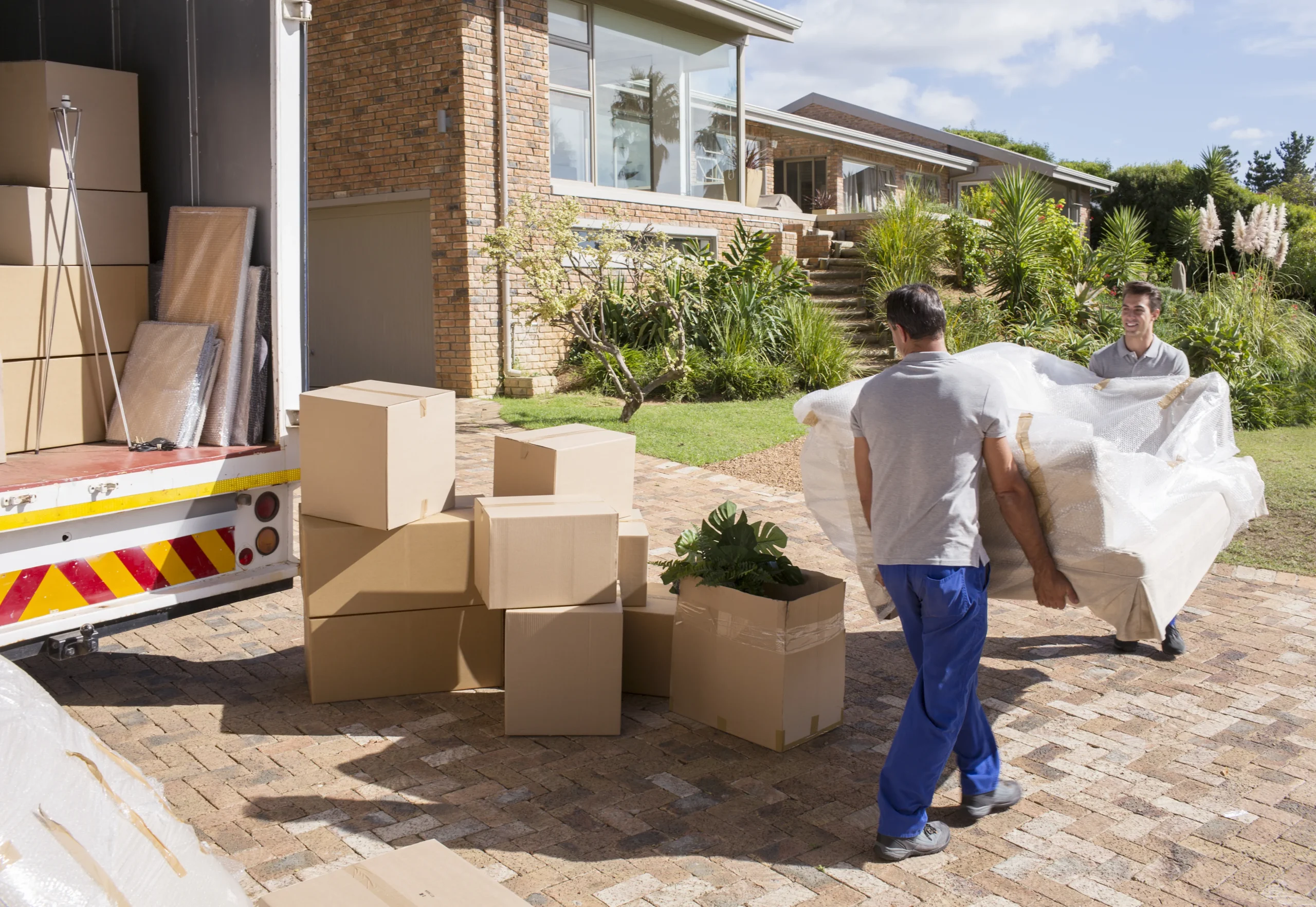 Team loading furniture into a cargo truck during a villa move