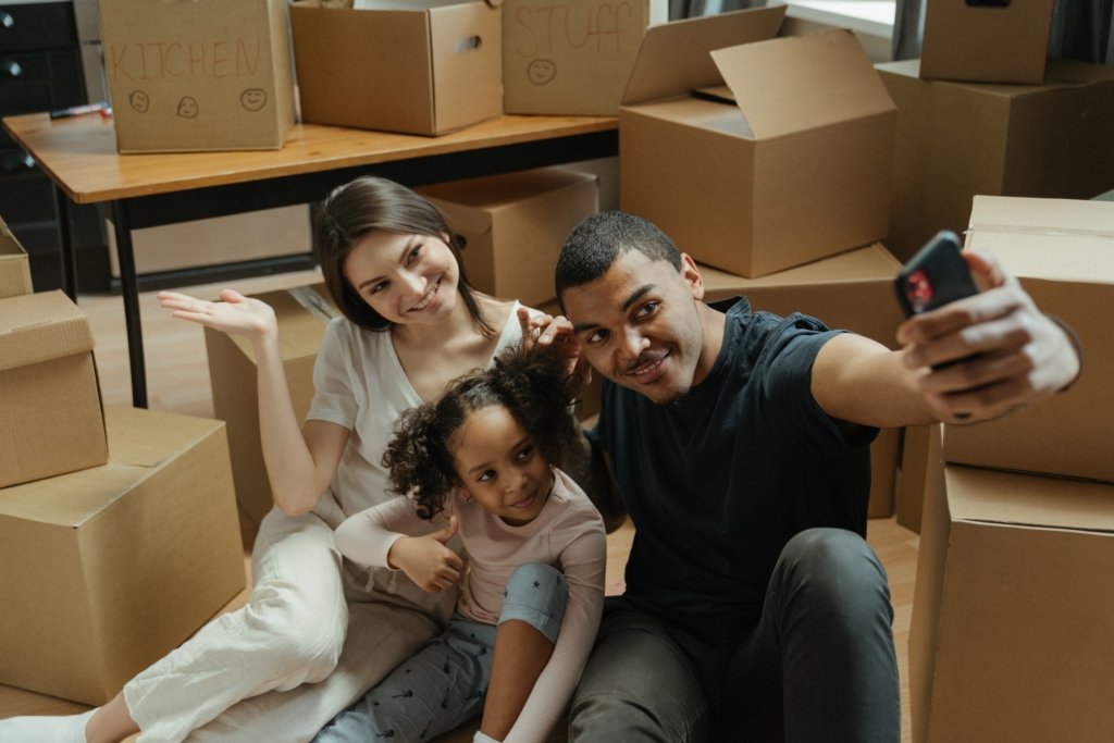 Posing family after a successful move into a new home