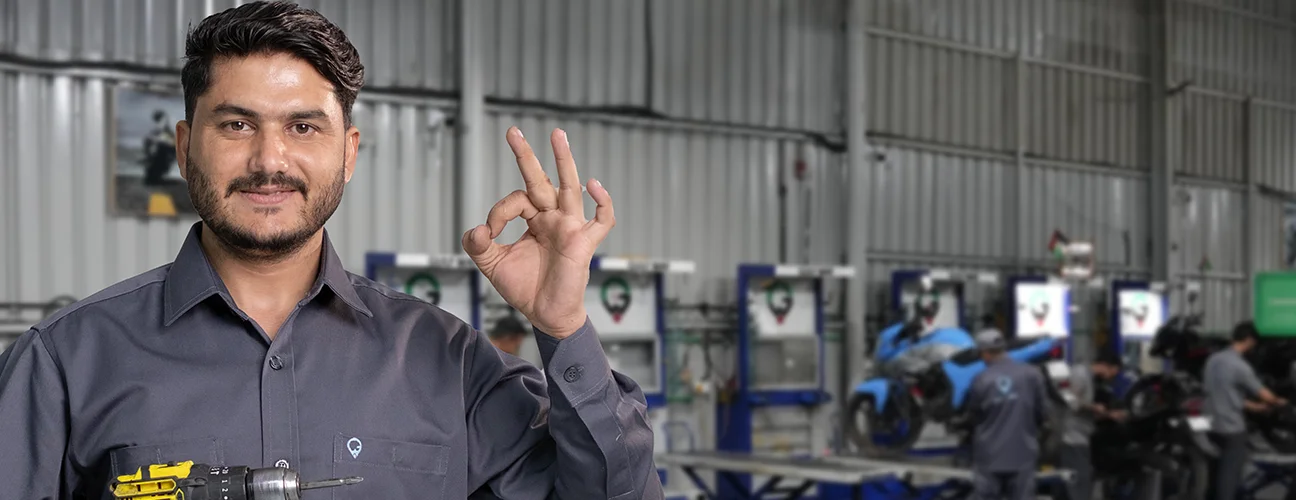 Mechanic With Drill in Hand & Happy Face Posing Camera